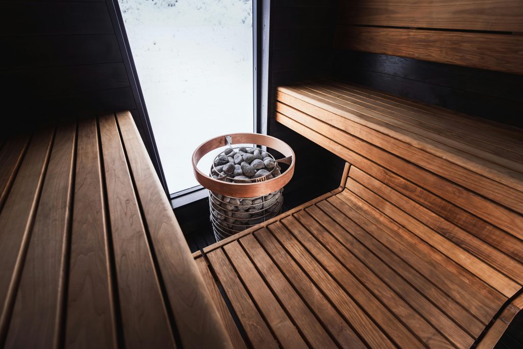 pexels photo 31092898 31092898 1 Elegant Nordic sauna interior featuring wooden benches and modern sauna heater.